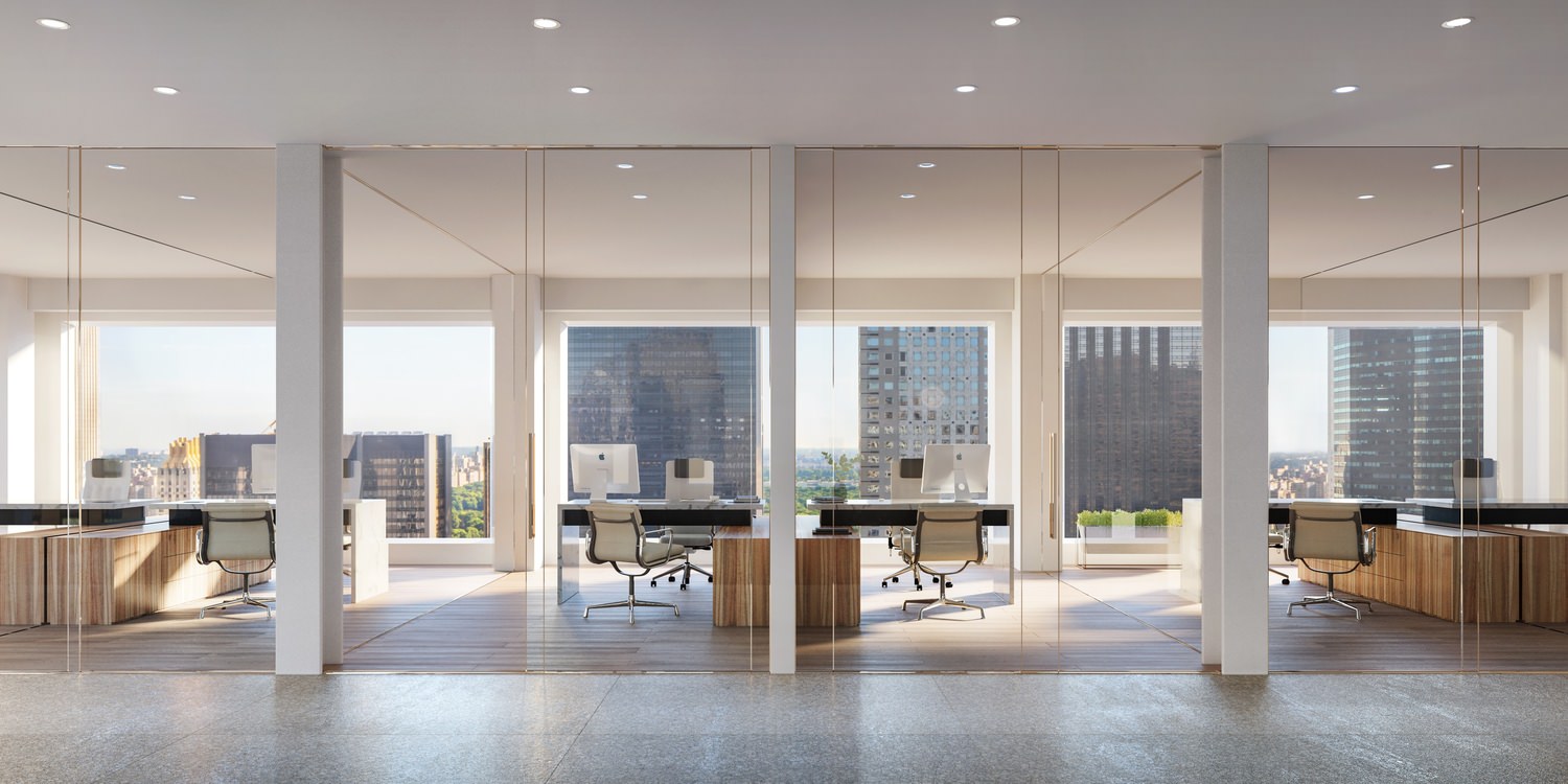 A view of many private offices that are each in their own glass room that has a door and windows.