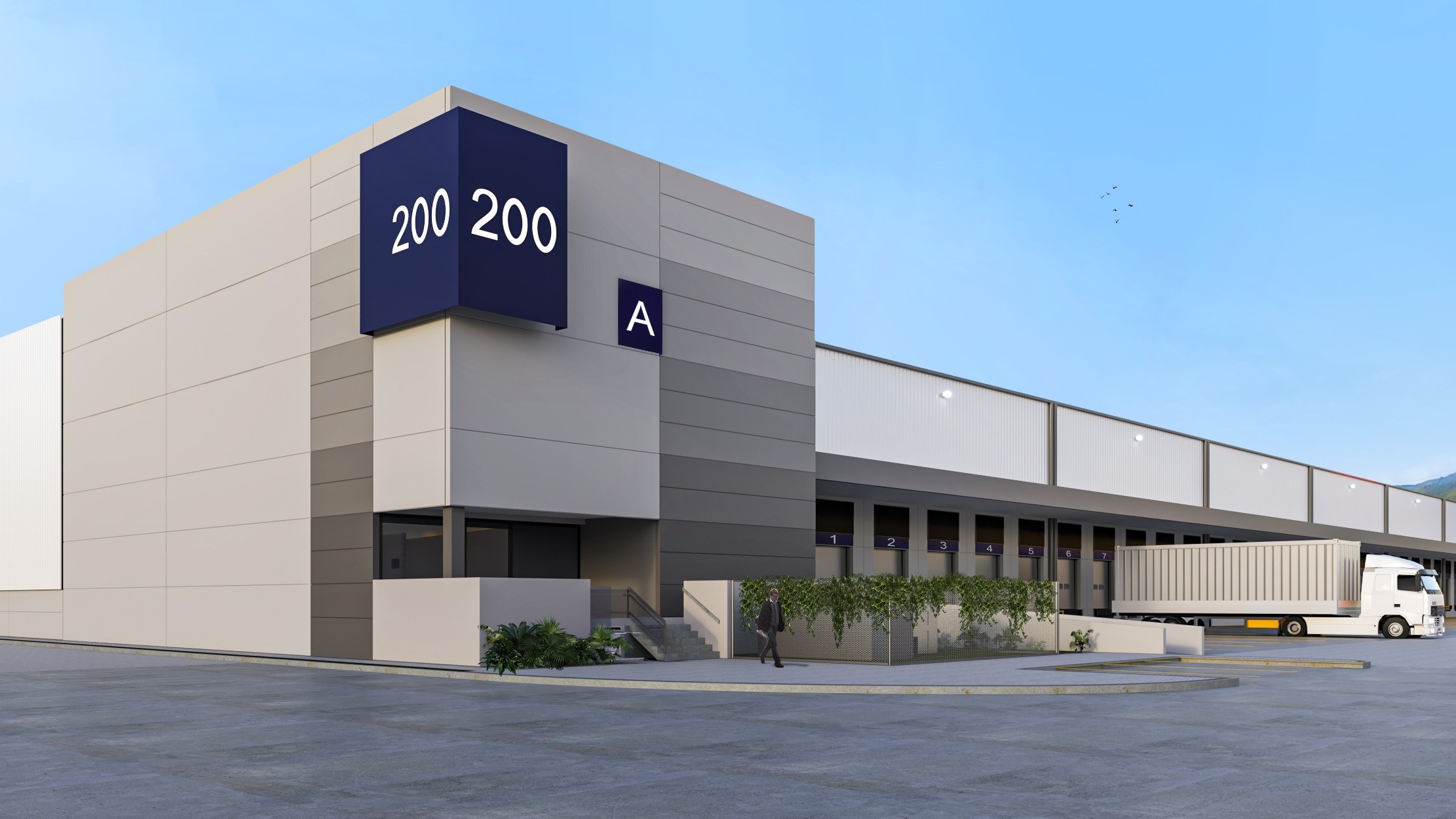 A large warehouse that has an A 200 sign on it and there is a semi truck that is backed into a loading dock