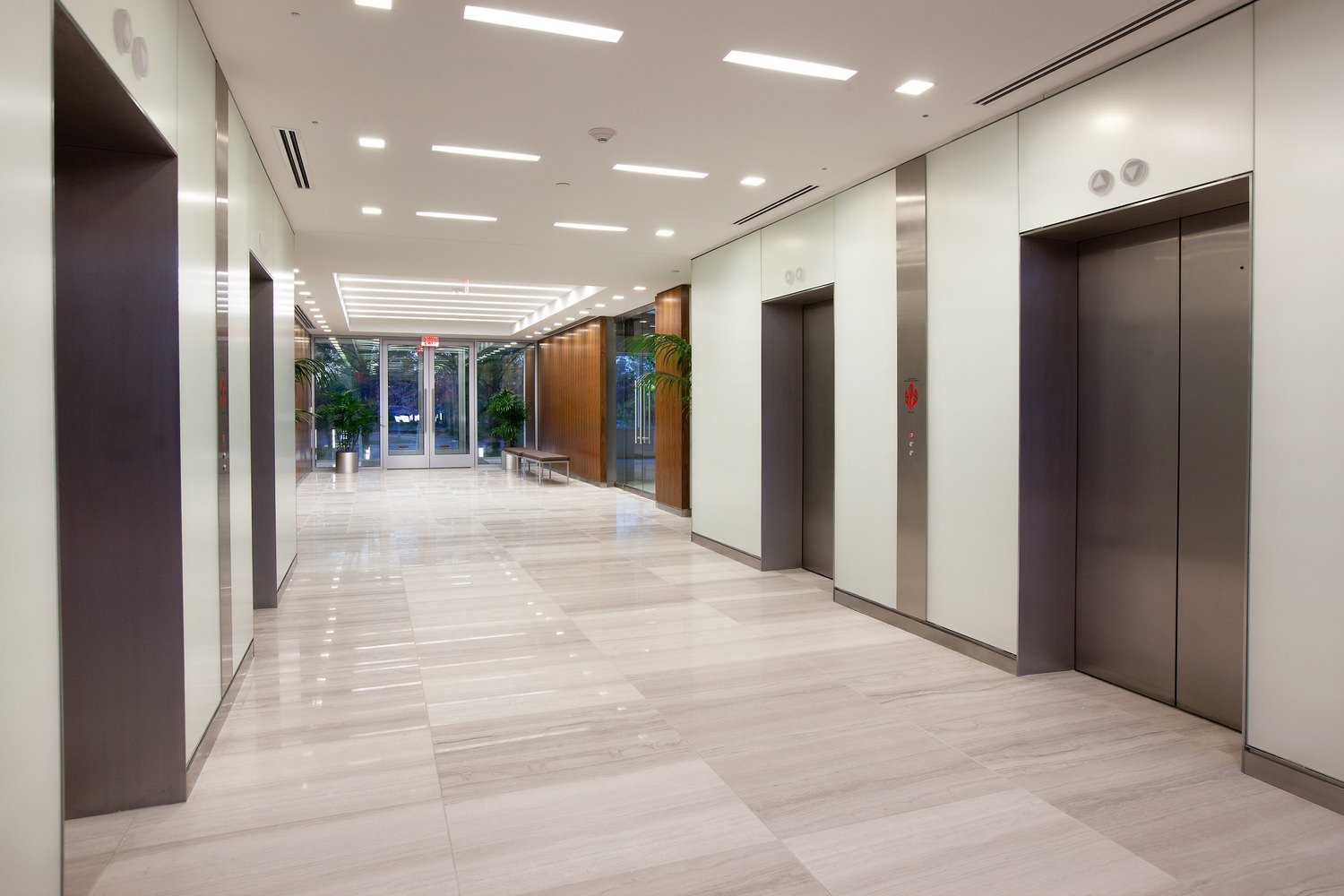 View of the entrance and corridor of a large building, photographed from the inside end.