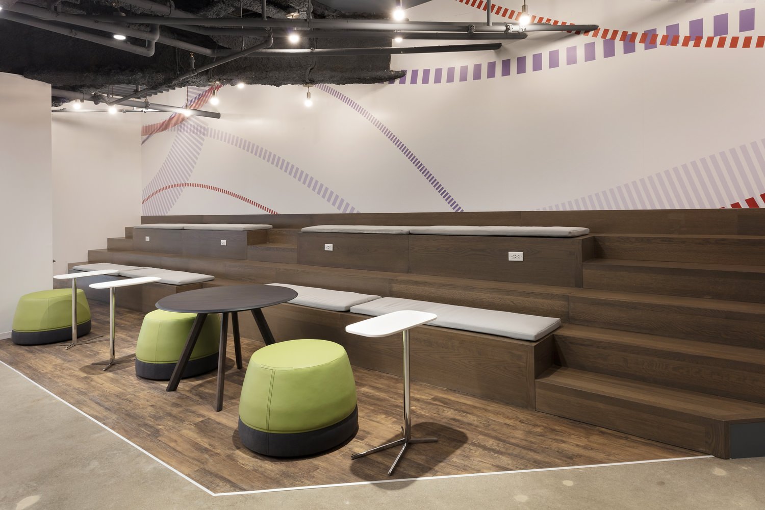 Auditorium area with benches and tables.
