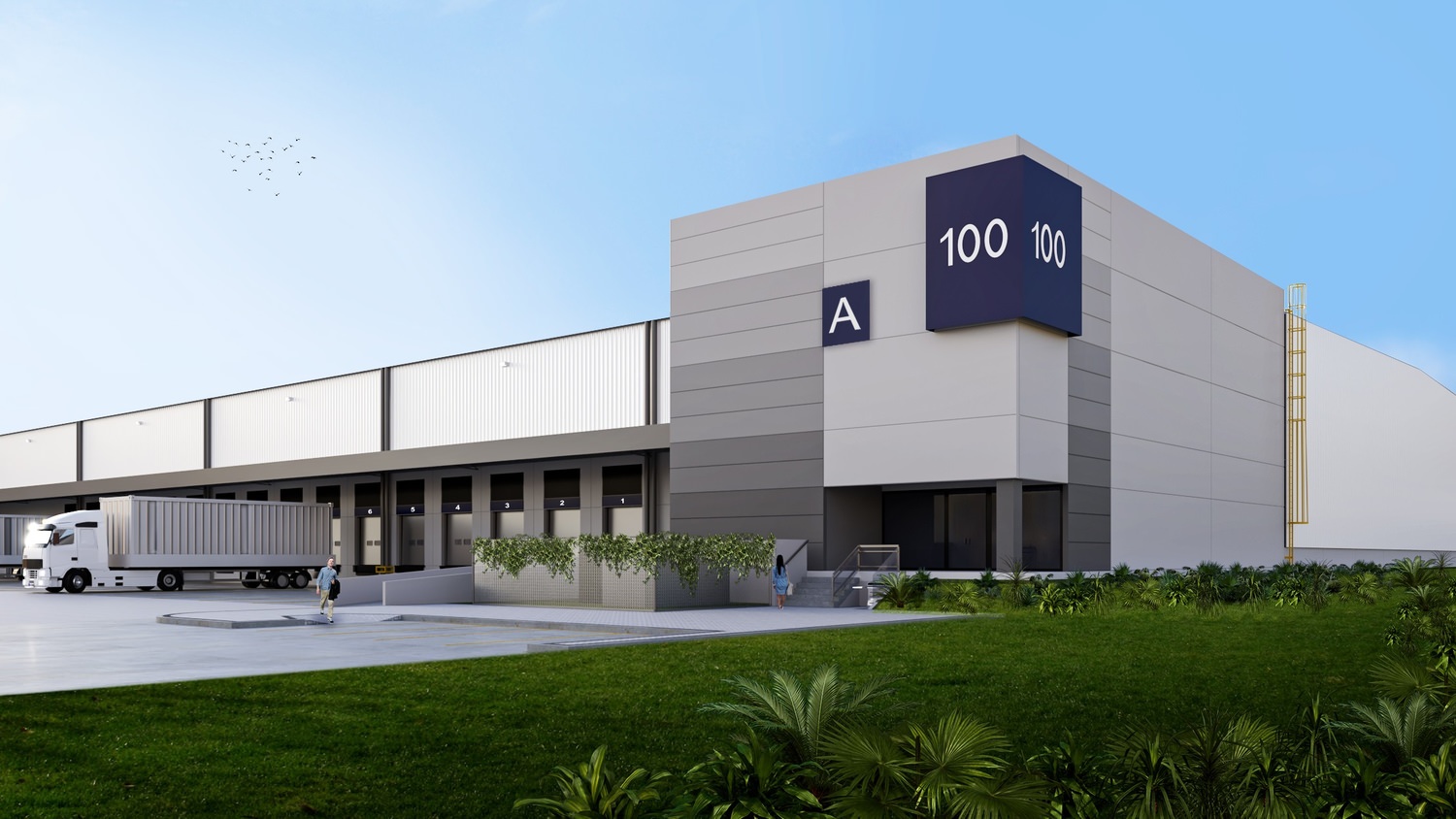 A large warehouse that has a 100 sign on the side of it and a semi truck that is backed up to the loading dock.