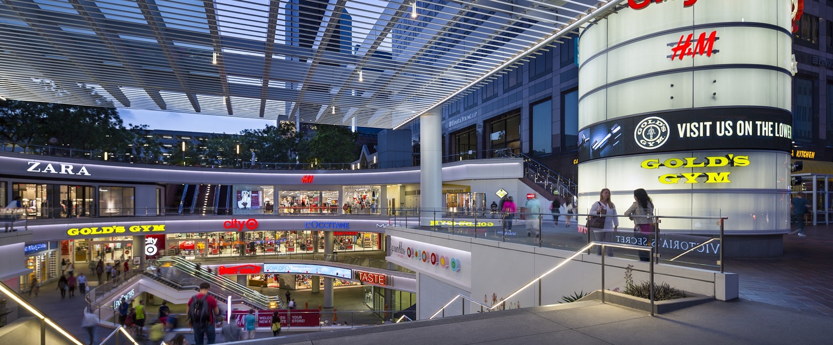 A modern indoor shopping center with Zara, H&M, Target, Gold's Gym, L'Occitane, and Sport Chalet locations.