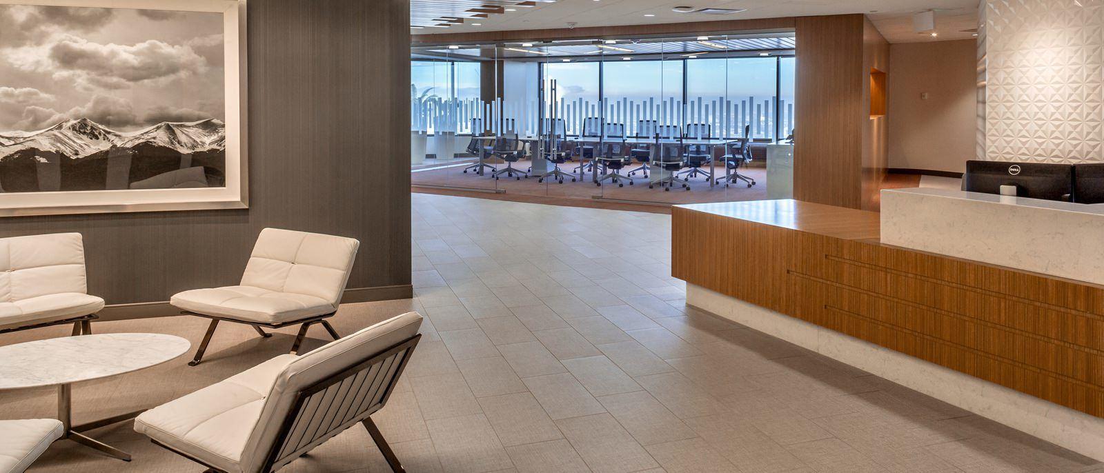 View of a lobby with a glass conference room behind it.