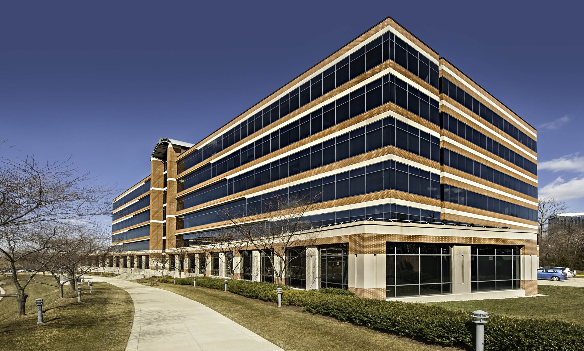 A large, brown brick office complex with dark tinted windows.