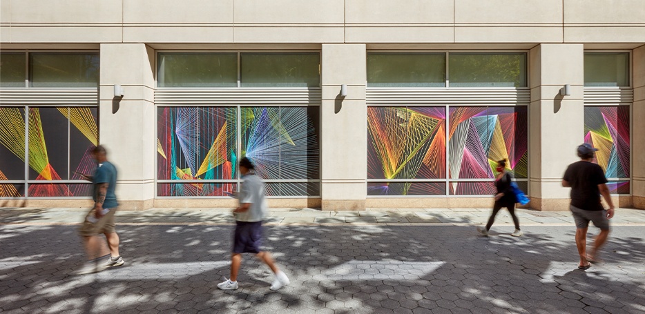 People walking by Rays art installation